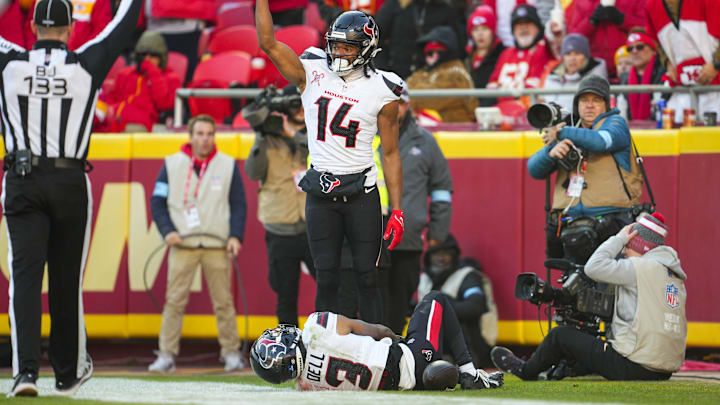 Dec 21, 2024; Kansas City, Missouri, USA; Houston Texans wide receiver Jared Wayne (14) calls for medical staff after an injury to wide receiver Tank Dell (3) during the second half against the Kansas City Chiefs at GEHA Field at Arrowhead Stadium. Mandatory Credit: Jay Biggerstaff-Imagn Images