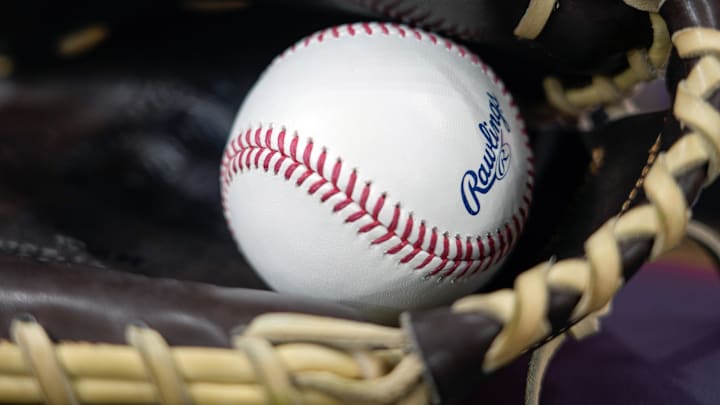 Apr 18, 2025; Milwaukee, Wisconsin, USA;  General view of a baseball in a glove during batting practice prior to the game between the Athletics and Milwaukee Brewers at American Family Field. Mandatory Credit: Jeff Hanisch-Imagn Images
