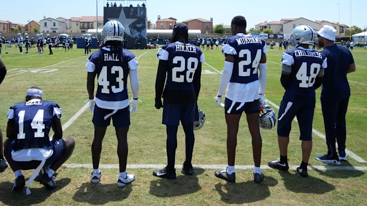 Dallas Cowboys safety Markquese Bell (14), linebacker Darius Harris (43), safety Malik Hooker (28), safety Israel Mukuamu (24), and cornerback Zion Childress (48) watch from the sidelines at training camp at the River Ridge Fields.