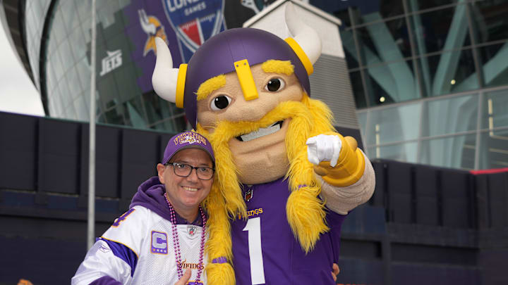 Oct 6, 2024; London, United Kingdom; A Minnesota Vikings fan poses with mascot Viktor before the NFL London Game at Tottenham Hotspur Stadium. Mandatory Credit: Kirby Lee-Imagn Images