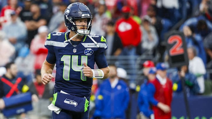 Aug 15, 2025; Seattle, Washington, USA; Seattle Seahawks quarterback Sam Darnold (14) reacts following a rushing touchdown by a teammate against the Kansas City Chiefs during the first quarter at Lumen Field. Aug 15, 2025; Seattle, Washington, USA; Seattle Seahawks quarterback Sam Darnold (14) reacts following a rushing touchdown by a teammate against the Kansas City Chiefs during the first quarter at Lumen Field.