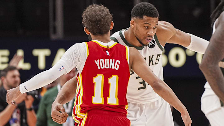Mar 4, 2025; Atlanta, Georgia, USA; Milwaukee Bucks forward Giannis Antetokounmpo (34) reacts with Atlanta Hawks guard Trae Young (11) after the Bucks defeated the Hawks at State Farm Arena. Mandatory Credit: Dale Zanine-Imagn Images
