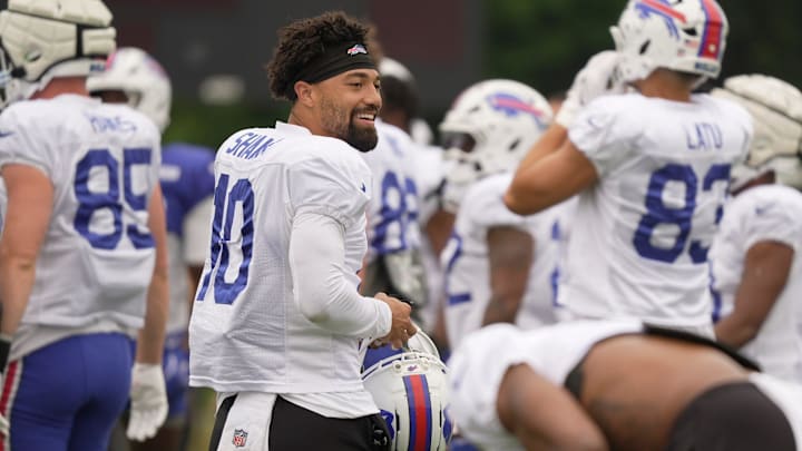 Buffalo Bills WR Khalil Shakir smiles at teammates as he heads to an area to participate in stretches during Training Camp.