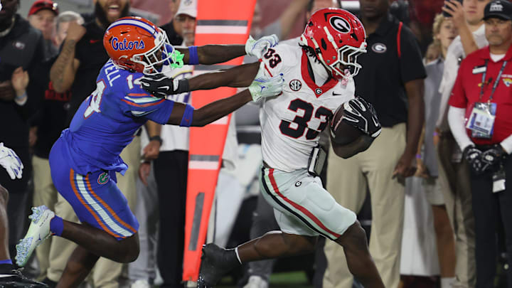 Florida Gators defensive back Jordan Castell (14) pushes Georgia Bulldogs running back Chauncey Bowens (33)