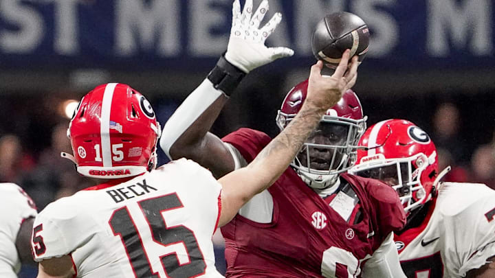 Dec 2, 2023; Atlanta, GA, USA;  Alabama Crimson Tide defensive lineman Jaheim Oatis (91) pressures Georgia Bulldogs quarterback Carson Beck (15) at Mercedes-Benz Stadium. Alabama defeated Georgia 27-24 to claim the SEC Championship. Mandatory Credit: Gary Cosby Jr.-Imagn Images
