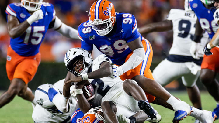 Sep 7, 2024; Gainesville, Florida, USA; Florida Gators defensive lineman Cam Jackson (99) and Florida Gators edge George Gumbs Jr. (34) tackle Samford Bulldogs quarterback Quincy Crittendon (2) during the first half at Ben Hill Griffin Stadium. Mandatory Credit: Matt Pendleton-Imagn Images Sep 7, 2024; Gainesville, Florida, USA; Florida Gators defensive lineman Cam Jackson (99) and Florida Gators edge George Gumbs Jr. (34) tackle Samford Bulldogs quarterback Quincy Crittendon (2) during the first half at Ben Hill Griffin Stadium. Mandatory Credit: Matt Pendleton-Imagn Images