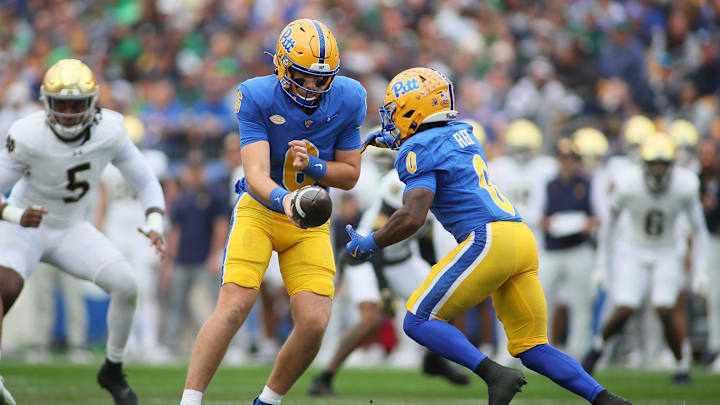 Pittsburgh Panthers quarterback Mason Heintschel (6) hands the ball off to running back Desmond Reid (0) during the first half against the Notre Dame Fighting Irish at Acrisure Stadium in Pittsburgh, PA on November 15, 2025.