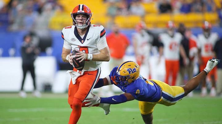Syracuse Orange quarterback Steve Angeli (9) looks downfield for an open receiver while being pressured by Pittsburgh Panthers linebacker Braylan Lovelace (0) during the first half at Acrisure Stadium in Pittsburgh, PA on September 17, 2026. Syracuse Orange quarterback Steve Angeli (9) looks downfield for an open receiver while being pressured by Pittsburgh Panthers linebacker Braylan Lovelace (0) during the first half at Acrisure Stadium in Pittsburgh, PA on September 17, 2026.