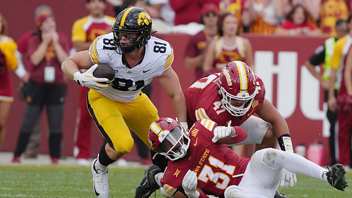 Iowa Hawkeyes tight end DJ Vonnahme (81) makes a catch around Iowa State Cyclones' defensive back Marcus Neal Jr.(31) and linebacker Kooper Ebel (47) during the fourth quarter in the Cy-Hawk football at Jack Trice Stadium on Sept. 6, 2025, in Ames, Iowa