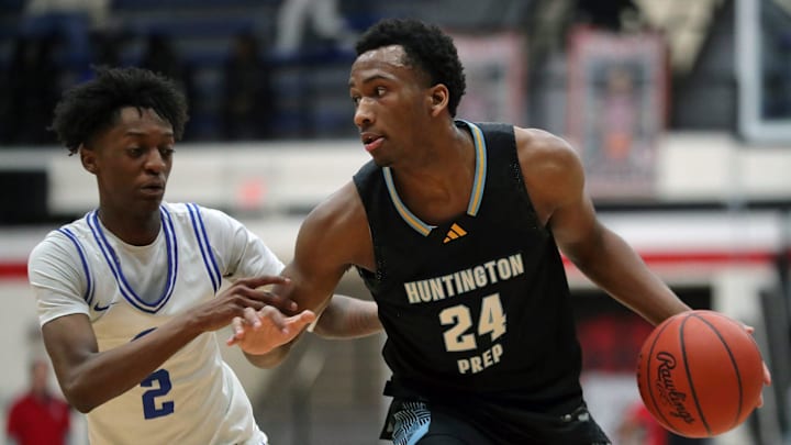 Huntington Prep gaurd Darryn Peterson, right, drives to the basket against Richmond Heights guard Demaris Winters Jr. during the first half of a basketball game in the Canton Play-By-Play Classic at Canton Memorial Field House, Saturday, Feb. 17, 2024, in Canton, Ohio.