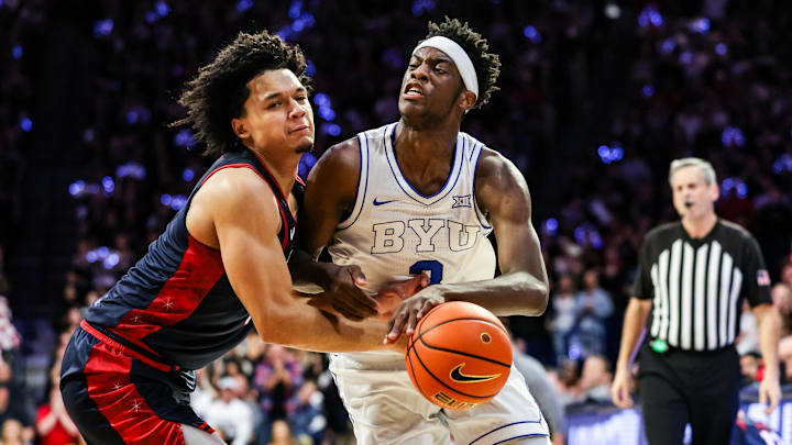 Feb 18, 2026; Tucson, Arizona, USA; Brigham Young Cougars forward AJ Dybantsa (3) dribbles the ball while Arizona Wildcats guard Brayden Burries (5) attempts to block him during the first half of the game at McKale Memorial Center. Mandatory Credit: Aryanna Frank-Imagn Images