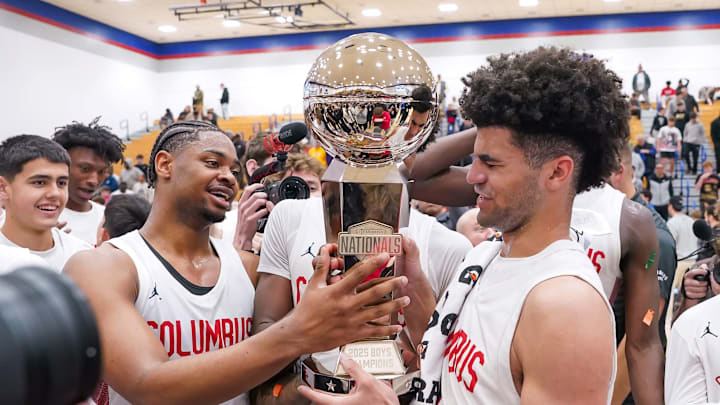 Cello Jackson (left) and Cayden Boozer of Columbus while admiring the trophy after defeating Dynamic Prep in title game of 2025 Chipotle Nationals.