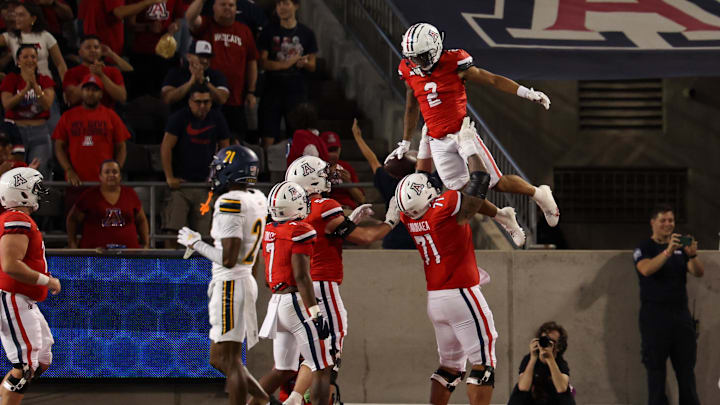 Sep 7, 2024; Tucson, Arizona, USA; Arizona Wildcats wide receiver Jeremiah Patterson (2) celebrates touchdown with Arizona Wildcats offensive lineman Jonah Savaiinaea (71) during third quarter against Northern Arizona Lumberjacks at Arizona Stadium. Mandatory Credit: Aryanna Frank-Imagn Images Sep 7, 2024; Tucson, Arizona, USA; Arizona Wildcats wide receiver Jeremiah Patterson (2) celebrates touchdown with Arizona Wildcats offensive lineman Jonah Savaiinaea (71) during third quarter against Northern Arizona Lumberjacks at Arizona Stadium. Mandatory Credit: Aryanna Frank-Imagn Images