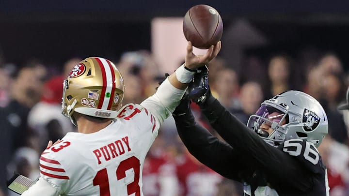 San Francisco 49ers quarterback Brock Purdy (13) tries to avoid Las Vegas Raiders linebacker Harvey Langi (56)