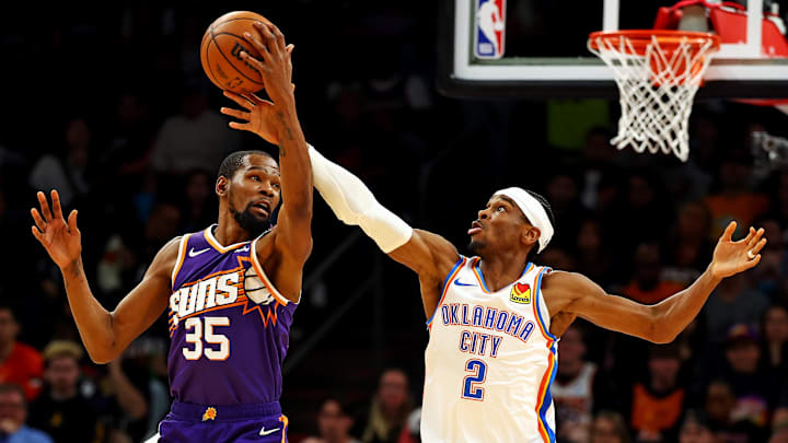 Mar 3, 2024; Phoenix, Arizona, USA; Phoenix Suns forward Kevin Durant (35) and Oklahoma City Thunder guard Shai Gilgeous-Alexander (2) go for the ball during the second quarter at Footprint Center. Mandatory Credit: Mark J. Rebilas-Imagn Images