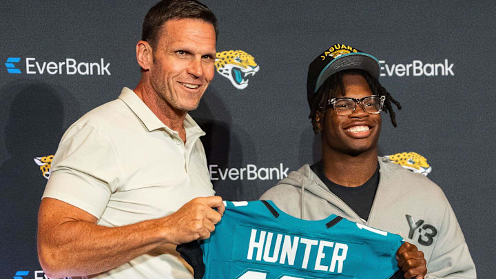 The Jacksonville Jaguars’ first-round pick, Colorado Buffaloes wide receiver and defensive back Travis Hunter, right, poses with Tony Boselli, Executive Vice President of Football Operations, left, with his jersey during a press conference Friday, March 25, 2025 at Miller Electric Center in Jacksonville, Fla. [Doug Engle/Florida Times-Union]
