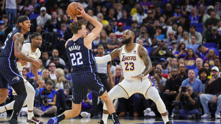 Los Angeles Lakers forward LeBron James (23) defends Orlando Magic forward Franz Wagner (22) during the first quarter at Amway Center. Los Angeles Lakers forward LeBron James (23) defends Orlando Magic forward Franz Wagner (22) during the first quarter at Amway Center.