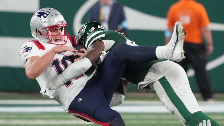 Sep 19, 2024; East Rutherford, New Jersey, USA; New England Patriots quarterback Drake Maye (10) gets sacked hard by New York Jets linebacker Jamien Sherwood (44) in the 4th quarter at MetLife Stadium. Sep 19, 2024; East Rutherford, New Jersey, USA; New England Patriots quarterback Drake Maye (10) gets sacked hard by New York Jets linebacker Jamien Sherwood (44) in the 4th quarter at MetLife Stadium.