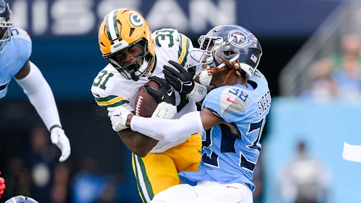 Sep 22, 2024; Nashville, Tennessee, USA;  Tennessee Titans cornerback L'Jarius Sneed (38) tackles Green Bay Packers running back Emanuel Wilson (31) during the first half at Nissan Stadium.