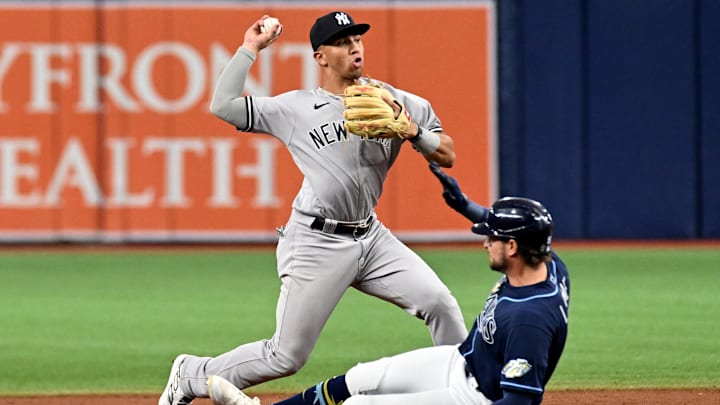 Aug 26, 2023; St. Petersburg, Florida, USA; New York Yankees shortstop Oswaldo Peraza (91) attempts to turn a double play as Tampa Bay Rays right fielder Josh Lowe (15) slides in the eighth inning at Tropicana Field. Mandatory Credit: Jonathan Dyer-Imagn Images