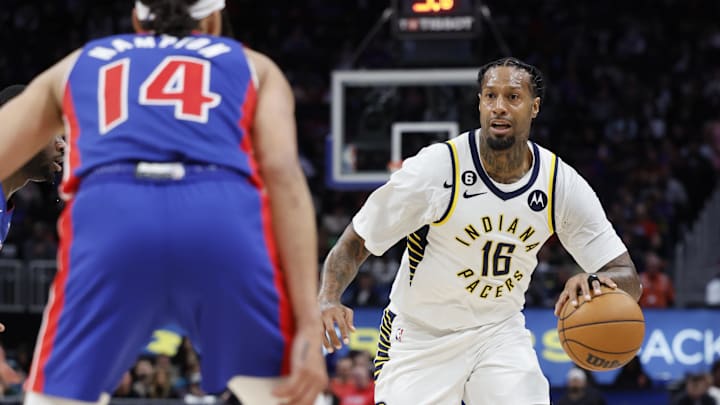 Mar 11, 2023; Detroit, Michigan, USA;  Indiana Pacers forward James Johnson (16) dribbles the ball against Detroit Pistons guard R.J. Hampton (14) in the second half at Little Caesars Arena. Mandatory Credit: Rick Osentoski-Imagn Images