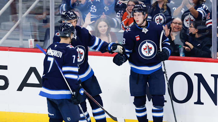 Sep 25, 2024; Winnipeg, Manitoba, CAN; Winnipeg Jets forward Brad Lambert (93) is congratulated by his teammates on his goal against the Edmonton Oilers during the third  period at Canada Life Centre. Mandatory Credit: Terrence Lee-Imagn Images