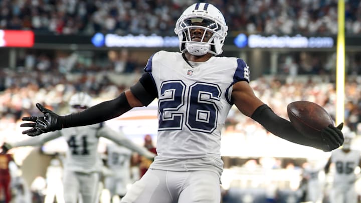 Dallas Cowboys cornerback Daron Bland carries the ball after an interception for a touchdown against Washington.