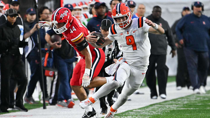 Oct 14, 2023; College Park, Maryland, USA;  Illinois Fighting Illini quarterback Luke Altmyer (9) cuts by Maryland Terrapins linebacker Caleb Wheatland (44) for a first down during the second half at SECU Stadium. Mandatory Credit: Tommy Gilligan-Imagn Images