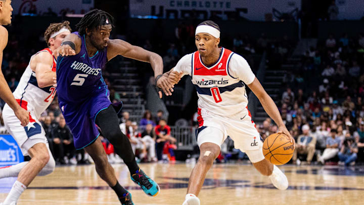 Mar 1, 2025; Charlotte, North Carolina, USA; Washington Wizards guard Bilal Coulibaly (0) drives past Charlotte Hornets center Mark Williams (5) during the fourth quarter at Spectrum Center. Mandatory Credit: Scott Kinser-Imagn Images