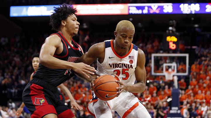 Mar 7, 2020; Charlottesville, Virginia, USA; Virginia Cavaliers forward Mamadi Diakite (25) controls the ball as Louisville Cardinals forward Dwayne Sutton (24) defends during the second half at John Paul Jones Arena. Mandatory Credit: Amber Searls-Imagn Images Mar 7, 2020; Charlottesville, Virginia, USA; Virginia Cavaliers forward Mamadi Diakite (25) controls the ball as Louisville Cardinals forward Dwayne Sutton (24) defends during the second half at John Paul Jones Arena. Mandatory Credit: Amber Searls-Imagn Images