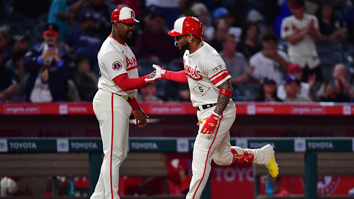 May 27, 2025; Anaheim, California, USA; Los Angeles Angels third baseman Yoan Moncada (5) is greeted by third base coach Bo Porter (88) after hitting a solo home run against the New York Yankees during the ninth inning at Angel Stadium. Mandatory Credit: Gary A. Vasquez-Imagn Images
