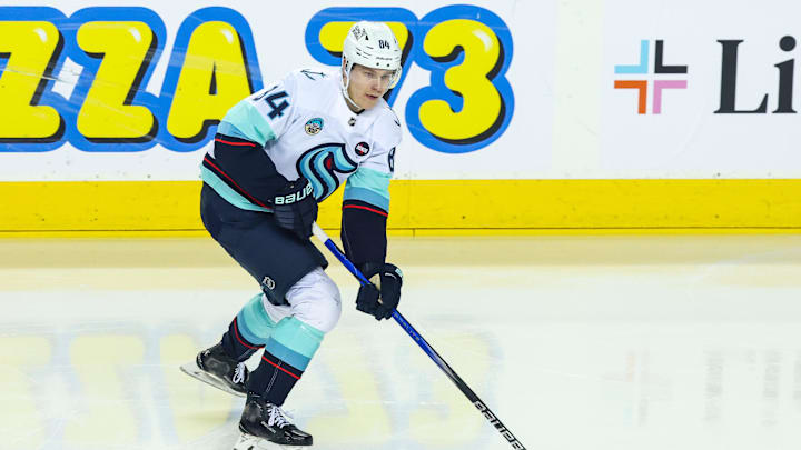 Feb 8, 2025; Calgary, Alberta, CAN; Seattle Kraken right wing Kaapo Kakko (84) skates with the puck against the Calgary Flames during the first period at Scotiabank Saddledome. Mandatory Credit: Sergei Belski-Imagn Images