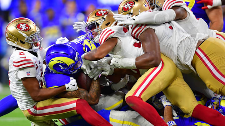 Oct 2, 2025; Inglewood, California, USA; Los Angeles Rams running back Kyren Williams (23) is tackled for no gain on fourth down to end the game against the San Francisco 49ers during overtime at SoFi Stadium. Mandatory Credit: Gary A. Vasquez-Imagn Images