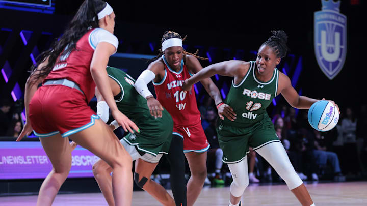 Mar 17, 2025; Miami, FL, USA; Rose BC guard Chelsea Gray (12) drives to the basket past Vinyl BC guard Rhyne Howard (10) during the third quarter of the Unrivaled Championship game at Wayfair Arena. Mandatory Credit: Sam Navarro-Imagn Images