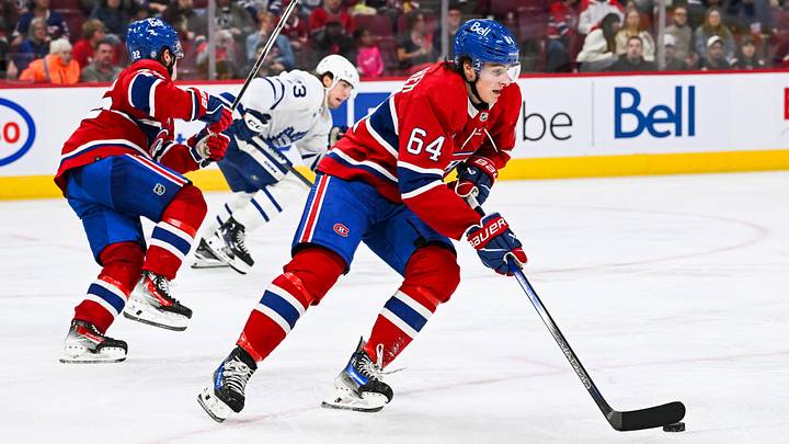 Sep 30, 2023; Montreal, Quebec, CAN; Montreal Canadiens defenseman David Reinbacher (64) plays the puck against the Toronto Maple Leafs during the third period at Bell Centre. Mandatory Credit: David Kirouac-Imagn Images