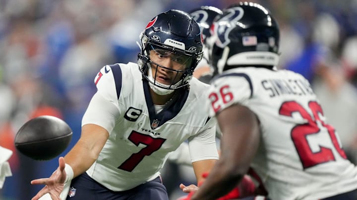 Houston Texans quarterback C.J. Stroud (7) tosses the ball to Houston Texans running back Devin