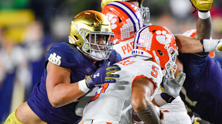 Nov 5, 2022; South Bend, Indiana, USA; Clemson Tigers quarterback DJ Uiagalelei (5) is sacked by Notre Dame Fighting Irish defensive lineman Howard Cross III (56) in the second quarter at Notre Dame Stadium. Nov 5, 2022; South Bend, Indiana, USA; Clemson Tigers quarterback DJ Uiagalelei (5) is sacked by Notre Dame Fighting Irish defensive lineman Howard Cross III (56) in the second quarter at Notre Dame Stadium.