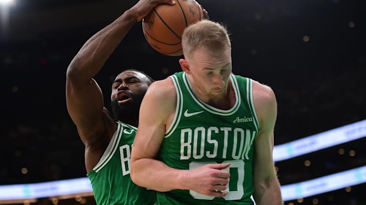 Mar 10, 2025; Boston, Massachusetts, USA;  Boston Celtics guard Jaylen Brown (7) grabs a rebound in front of forward Sam Hauser (30) during the second half at TD Garden. Mandatory Credit: Bob DeChiara-Imagn Images