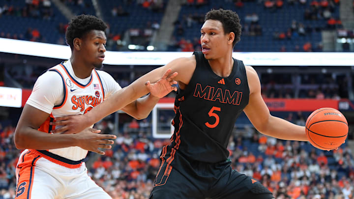 Miami forward Malik Reneau drives against Syracuse forward Tyler Betsey. The Hurricanes enter our projected March Madness bracket this week.