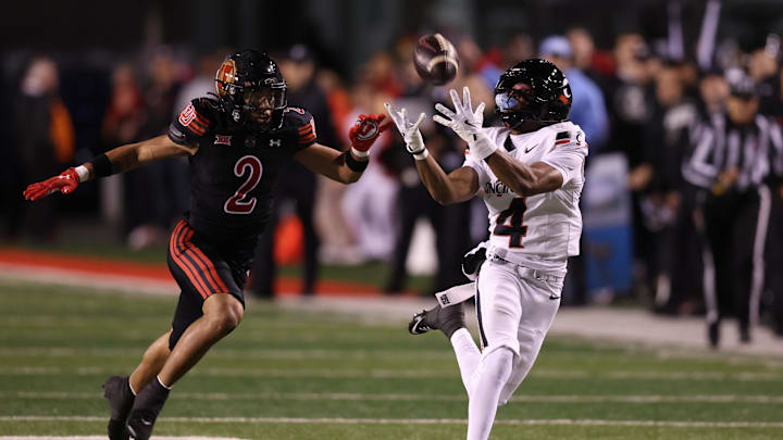 Nov 1, 2025; Salt Lake City, Utah, USA; Cincinnati Bearcats wide receiver Cyrus Allen (4) makes a catch against Utah Utes cornerback Smith Snowden (2) during the second quarter at Rice-Eccles Stadium. Mandatory Credit: Rob Gray-Imagn Images