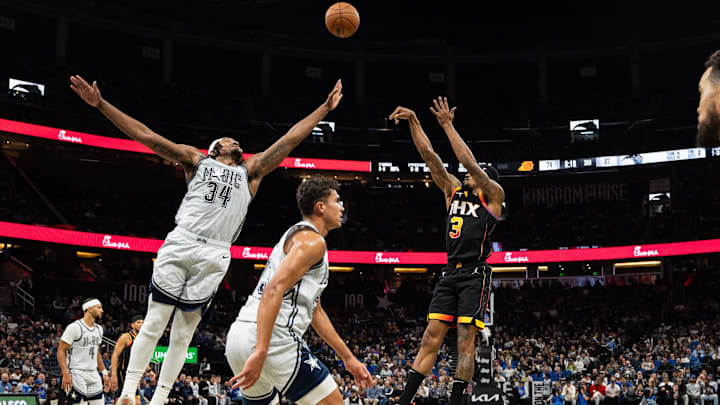 Dec 8, 2024; Orlando, Florida, USA; Phoenix Suns guard Bradley Beal (3) shoots the ball over Orlando Magic forward Wendell Carter Jr. in the third quarter at Kia Center. Mandatory Credit: Jeremy Reper-Imagn Images