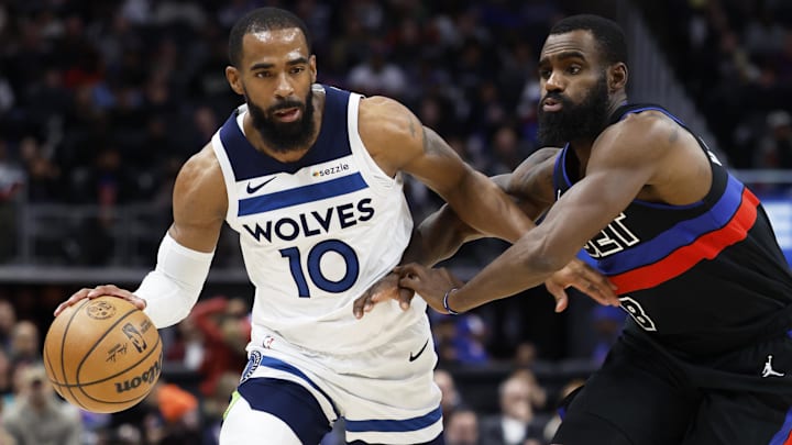Minnesota Timberwolves guard Mike Conley dribbles while defended by Detroit Pistons forward Tim Hardaway Jr. in the second half at Little Caesars Arena in Detroit on Jan. 4, 2025. 