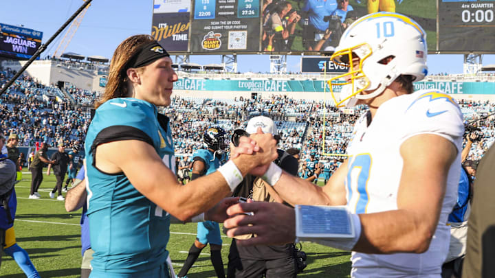 Nov 16, 2025; Jacksonville, Florida, USA; Jacksonville Jaguars quarterback Trevor Lawrence (16) shakes hands with Los Angeles Chargers quarterback Justin Herbert (10) following a Jaguars victory at EverBank Stadium. Mandatory Credit: Morgan Tencza-Imagn Images