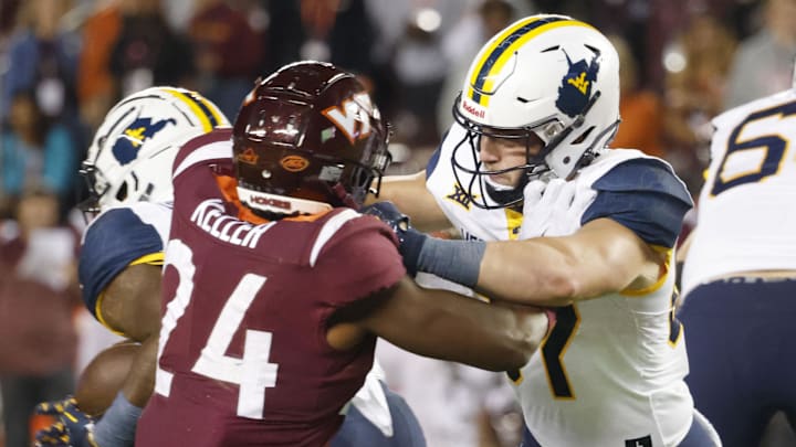 Sep 22, 2022; Blacksburg, Virginia, USA;  West Virginia Mountaineers wide receiver Cortez Braham (11) blocks Virginia Tech Hokies linebacker Jaden Keller (24) during the second quarter at Lane Stadium. Mandatory Credit: Reinhold Matay-Imagn Images