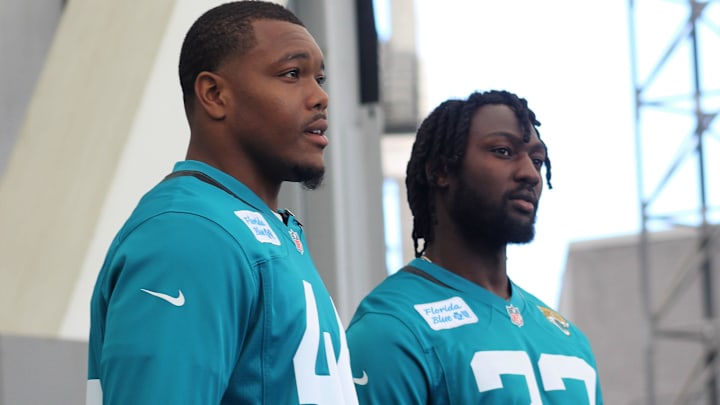 Jaguars linebackers Devin Lloyd and Travon Walker prepare to talk to players during the 2023.