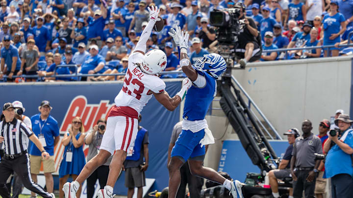 Sep 20, 2025; Memphis, Tennessee, USA; Arkansas Razorbacks defensive back Julian Neal (23) deflects a pass away from Memphis Tigers wide receiver Cortez Braham Jr. (4) during the second half at Simmons Bank Liberty Stadium. Mandatory Credit: Wesley Hale-Imagn Images