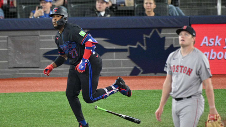 Sep 25, 2024; Toronto, Ontario, CAN;  Toronto Blue Jays first baseman Vladimir Guerrero Jr. (27) hits a double as  Boston Red Sox pitcher Richard Pitts (80) looks on in the fourth inning at Rogers Centre. Mandatory Credit: Dan Hamilton-Imagn Images