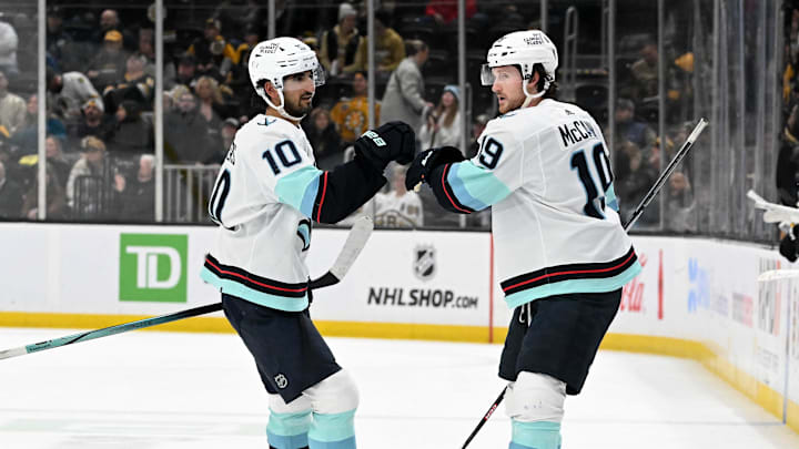 Feb 15, 2024; Boston, Massachusetts, USA; Seattle Kraken left wing Jared McCann (19) celebrates with center Matty Beniers (10) after scoring a goal against the Boston Bruins during the third period at the TD Garden. Mandatory Credit: Brian Fluharty-Imagn Images