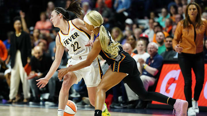 May 14, 2024; Uncasville, Connecticut, USA; Connecticut Sun guard DiJonai Carrington (21) strips the ball from Indiana Fever guard Caitlin Clark (22) in the second quarter at Mohegan Sun Arena. Mandatory Credit: David Butler II-Imagn Images