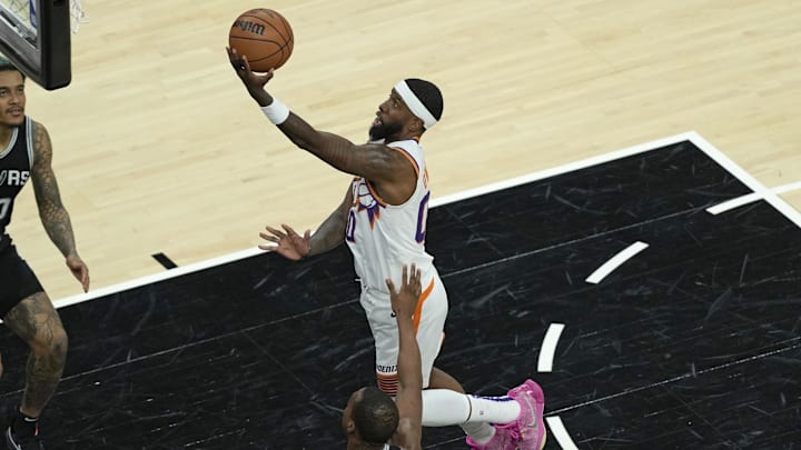 Feb 20, 2025; Austin, Texas, USA; Phoenix Suns forward Royce O'Neale (00) lays in a basket during the second half the San Antonio Spurs at Moody Center. Mandatory Credit: Scott Wachter-Imagn Images